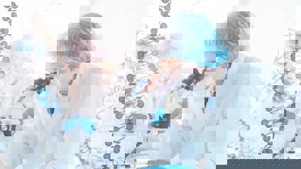 Scientist Analysing Sample Under Microscope