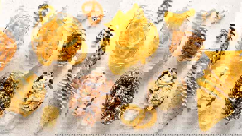 Selection Of Snack Foods Including Crisps, Popcorn And Pretzels