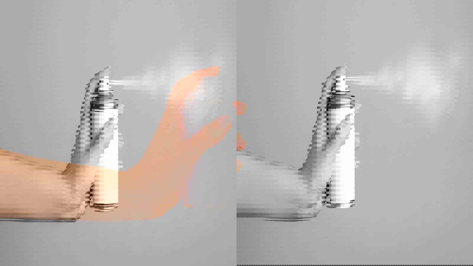 Person actuating an aerosol can