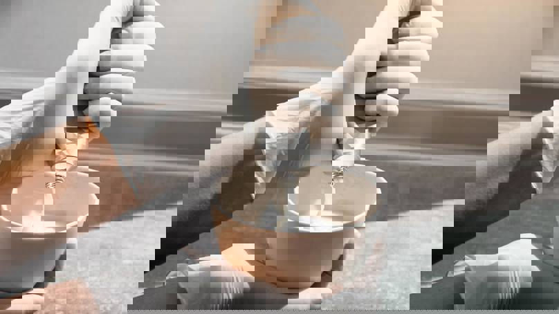 Hairdresser Mixing Colour In A Bowl