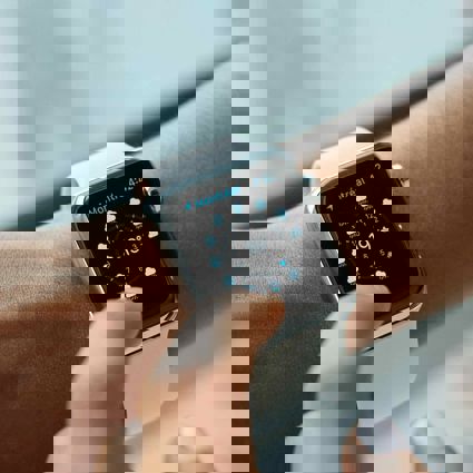 Person tapping the screen of a smart watch on their wrist
