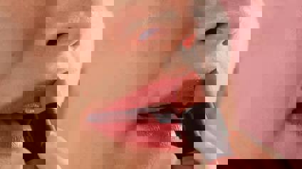 Woman Applying Lipstick