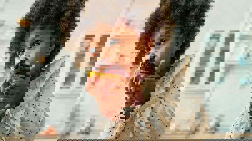 Child Biting Into A Muffin