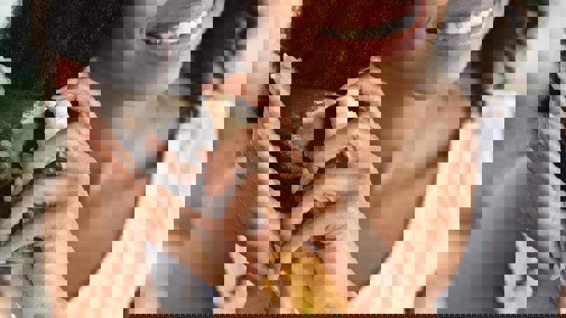 Person Spraying Hair Care Product On their Hair