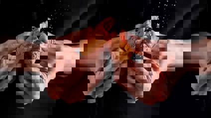 Hands Breaking Biscuit Into Two Pieces