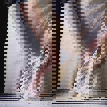 Baker stretching dough in hands