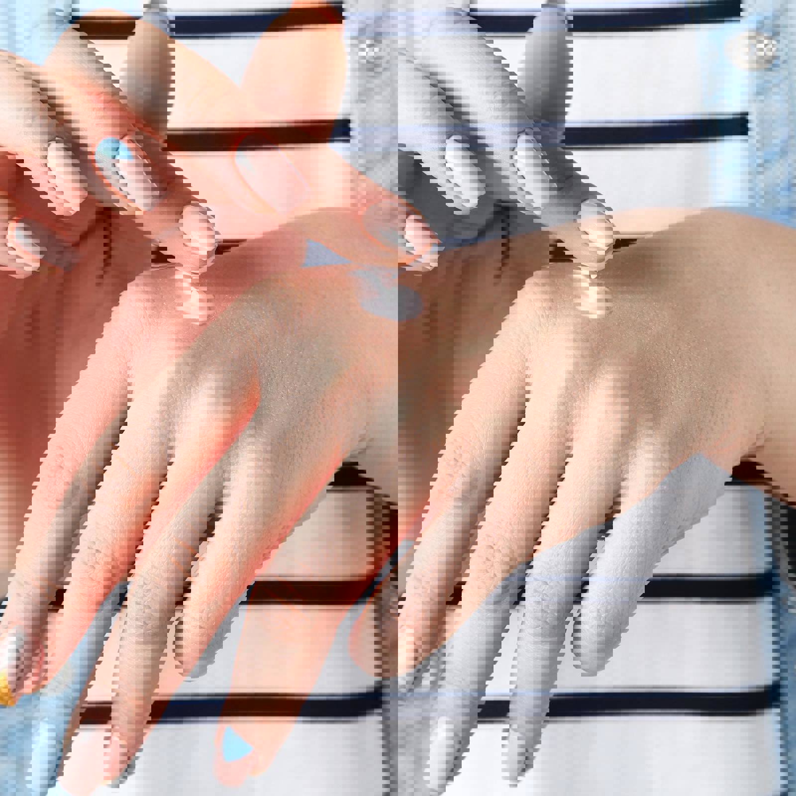 Female hands applying hand cream