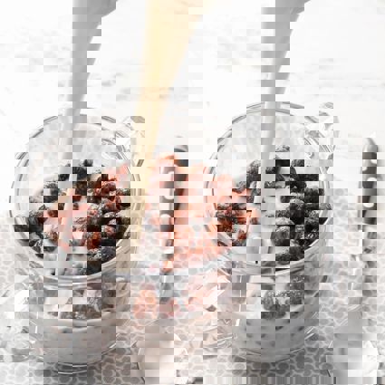 Milk being poured onto a bowl of chocolate cereal