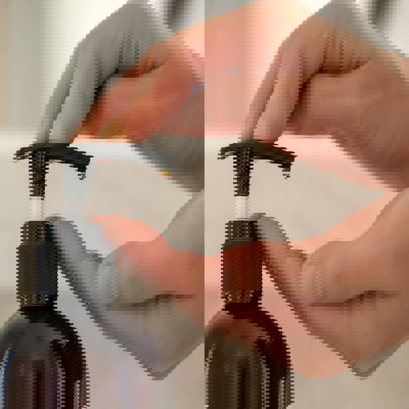Person pumping liquid soap from a bottle