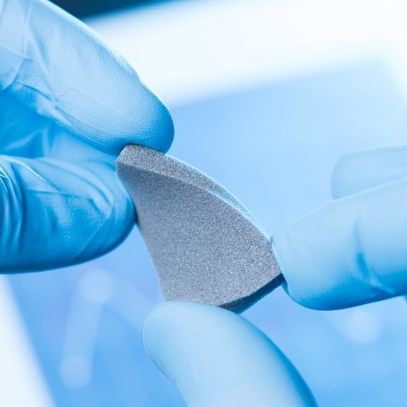 Researcher holding a sample of a new material