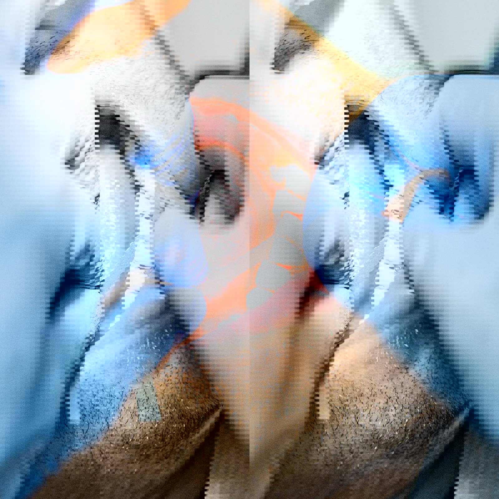 Dental professional using a dental strip between patients teeth