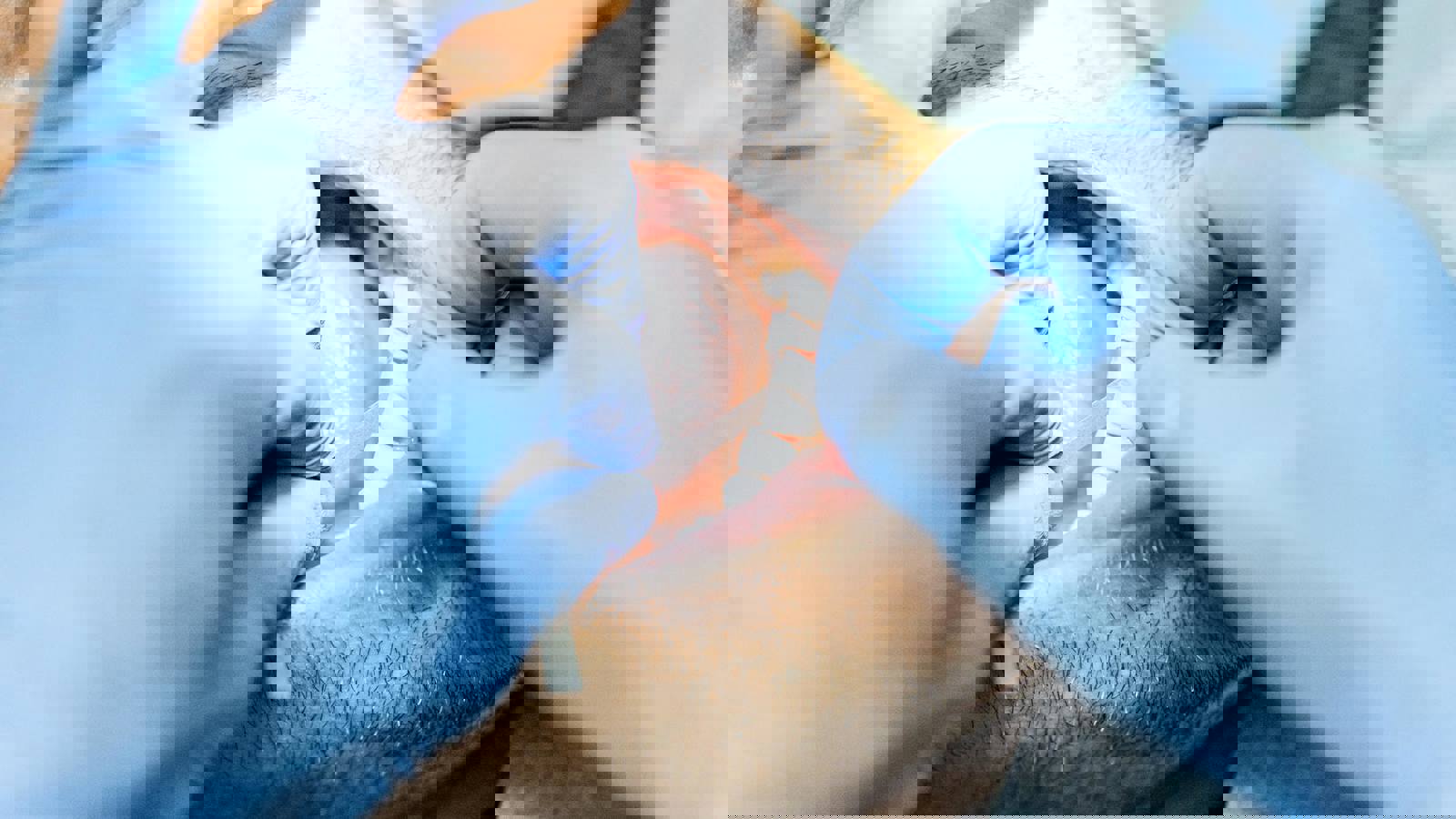 Dental professional using a dental strip between patients teeth