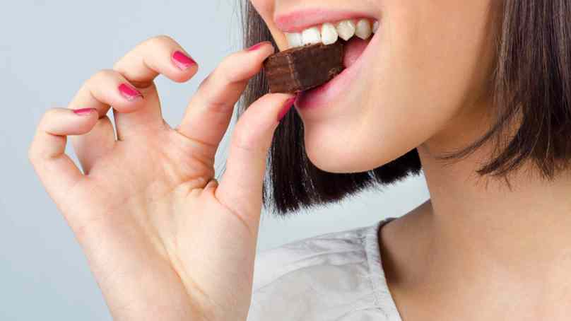 Person Biting Into A Brownie