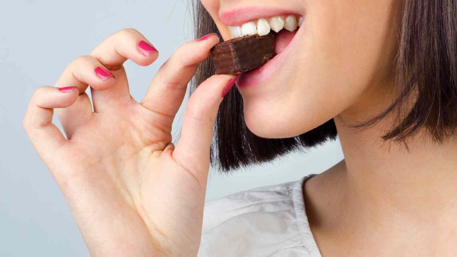 Person biting into a brownie