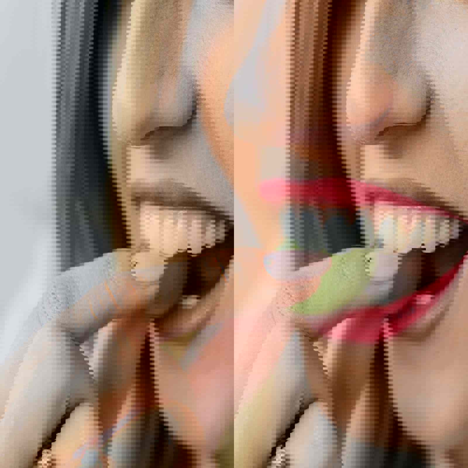 Person biting into a grape