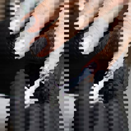 Nail technician applying nailpolish to client's fingernails 