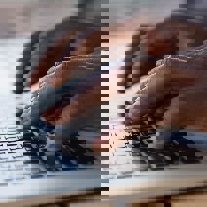 Person touch typing on a laptop