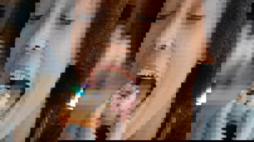 Woman Eating Mini Doughnut