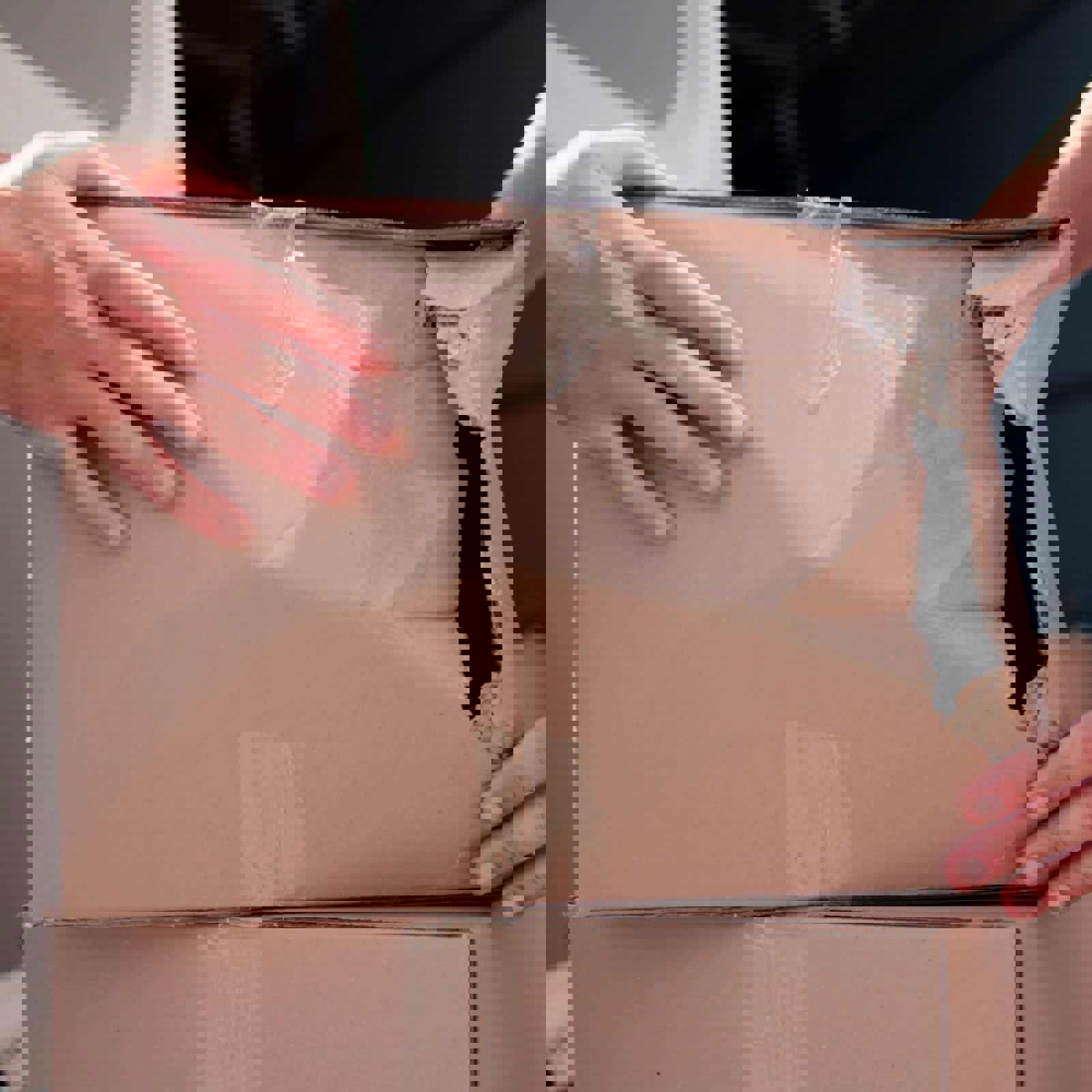 Delivery driver holding crushed box