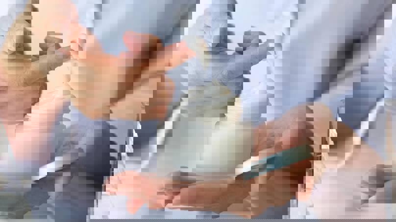 Person Holding Jar Of Face Cream