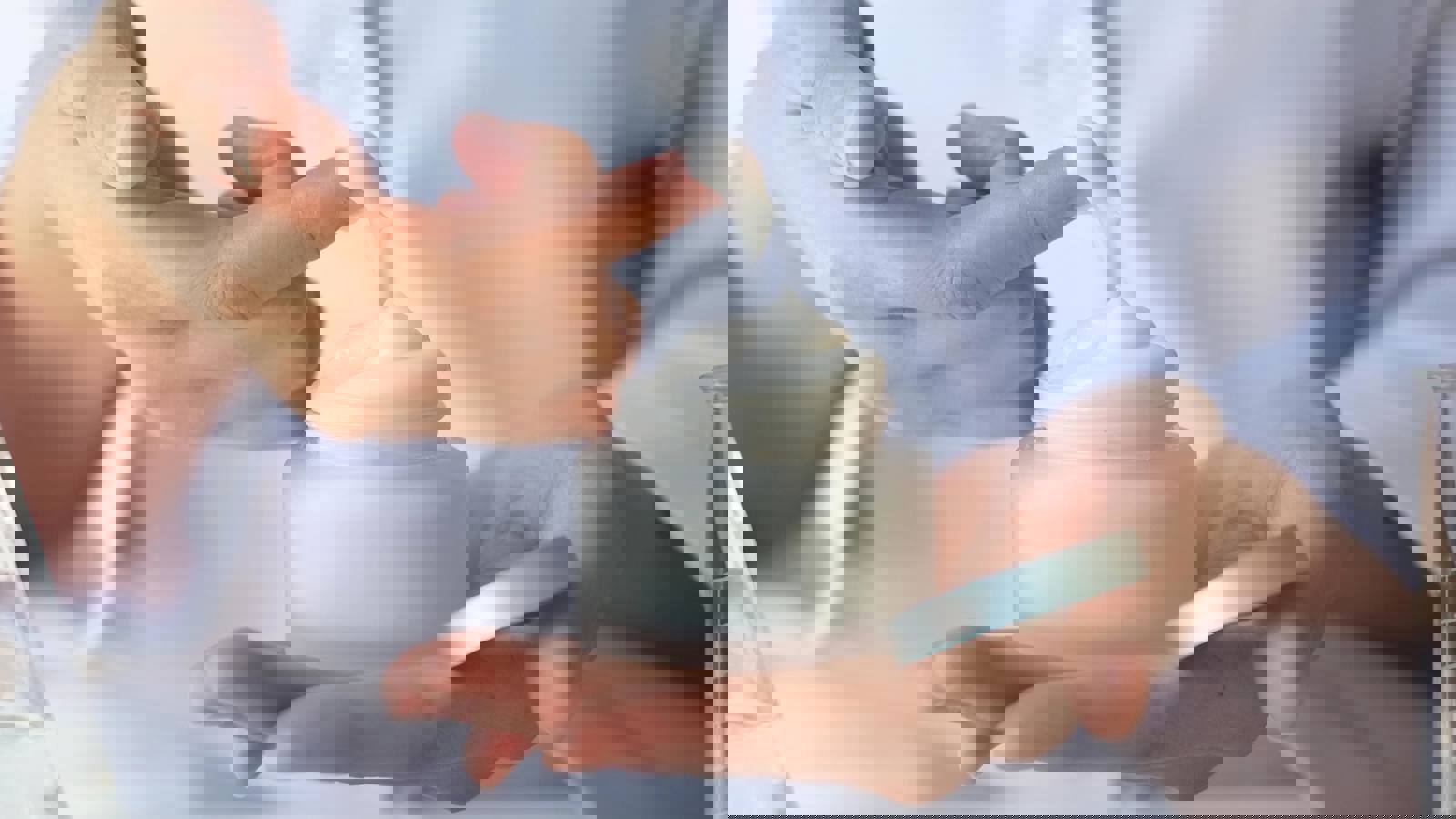 Person holding jar of cosmetic cream