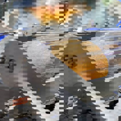 Bread in food grade plastic bag on conveyor belt