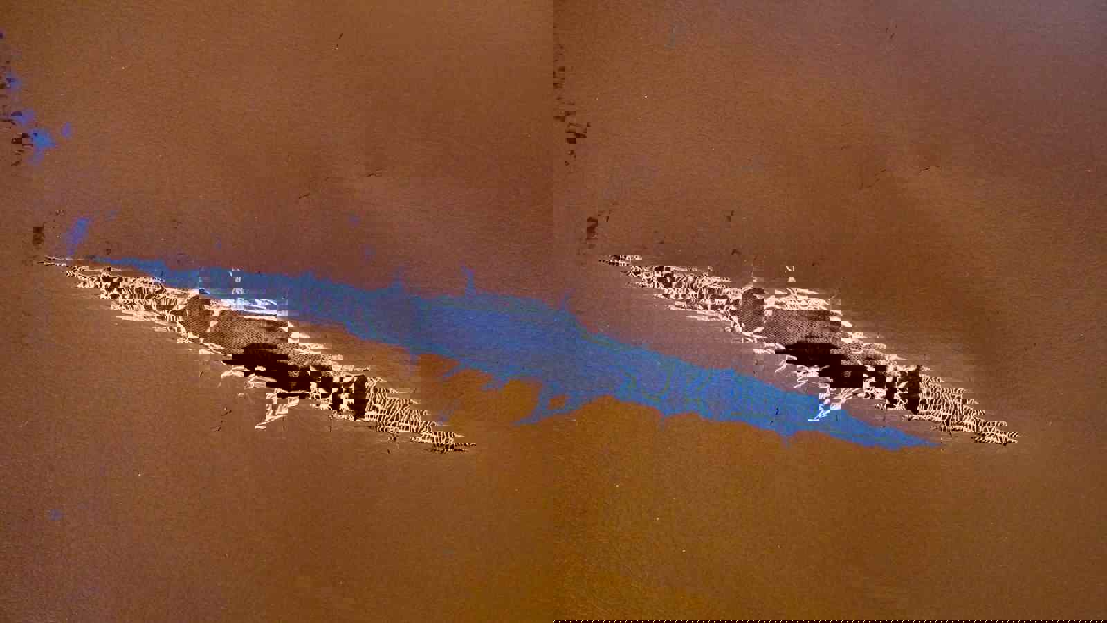 Deep tear in tan leather 