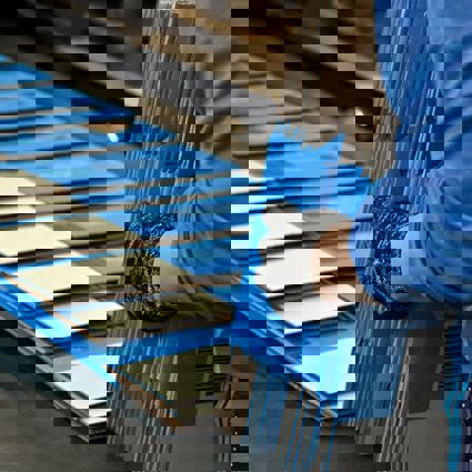 Flat boxes coming off a conveyor belt in a factorya