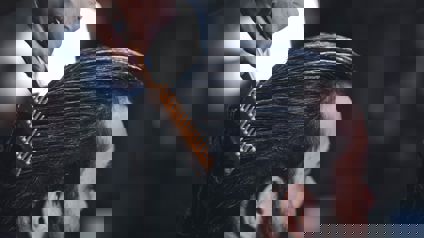 Hairdresser Combing Clients Hair