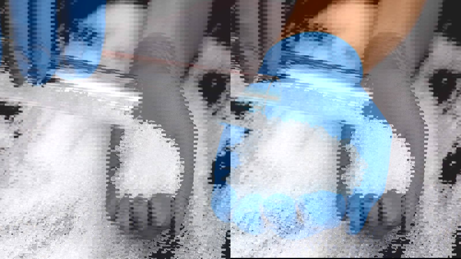 Person measuring polymers in pellet form