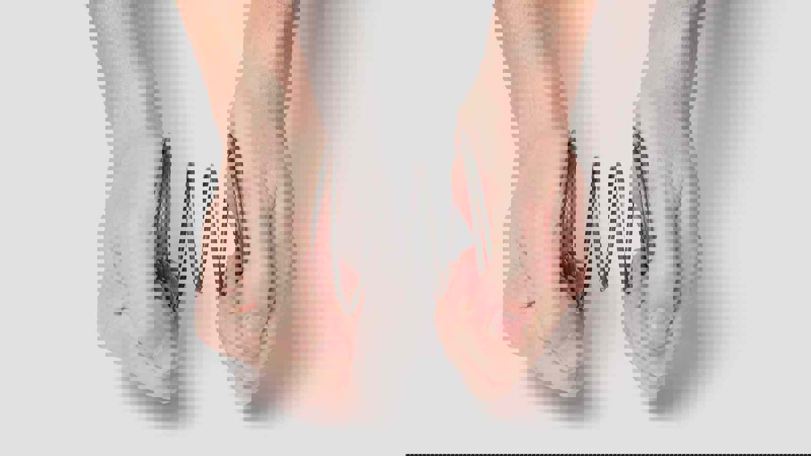 Person squeezing a spring together with hands