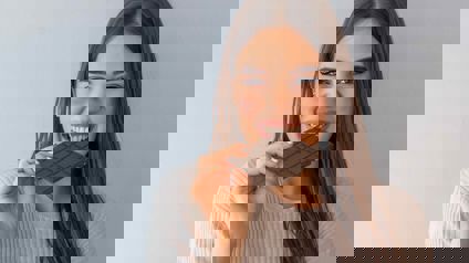 Person Eating A Block Of Chocolate