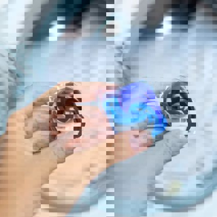 Person holding laundry gel capsule