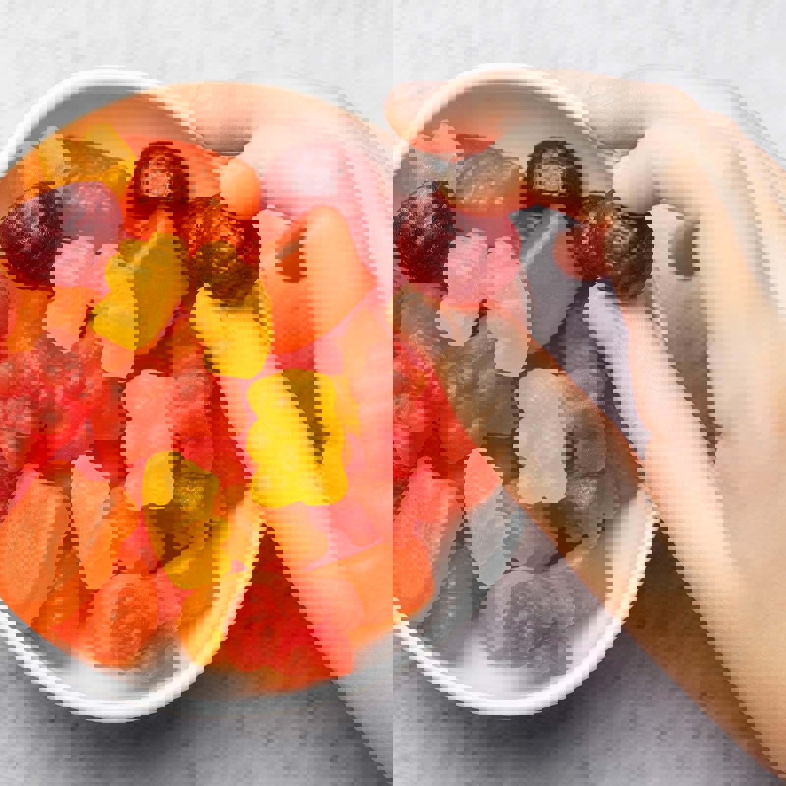 Person picking up a sweet from a bowl of sweets