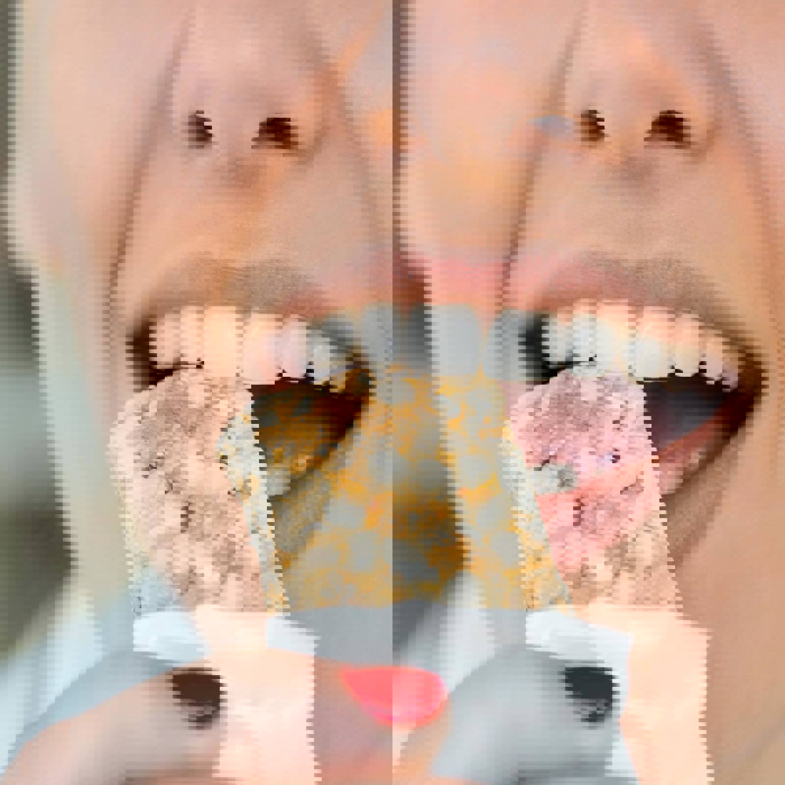 Person biting into a cereal bar