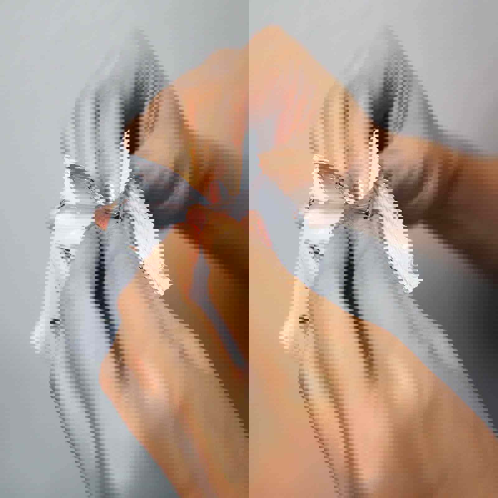 Person pulling open a sealed packet