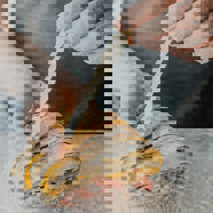 Person holding freshly made pasta