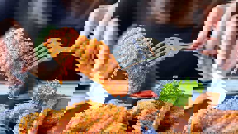 Person Picking Up Fried Chicken With A Fork