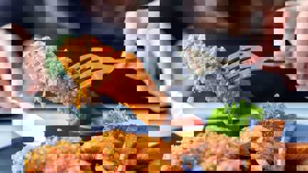 Person Picking Up Fried Chicken With A Fork