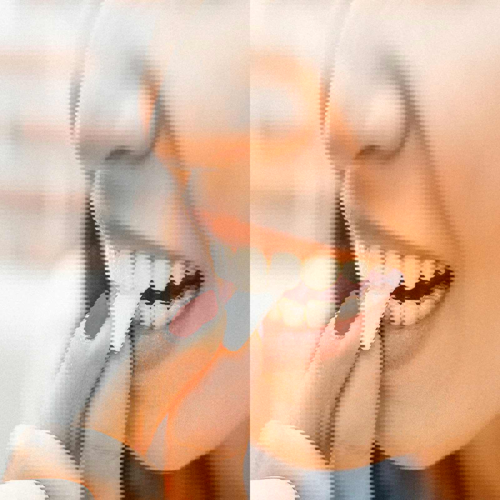 Person putting chewing gum into their mouth