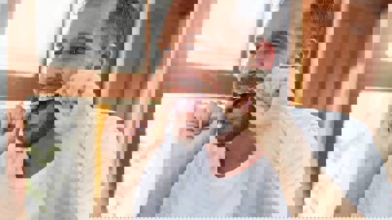 Person Flossing Teeth