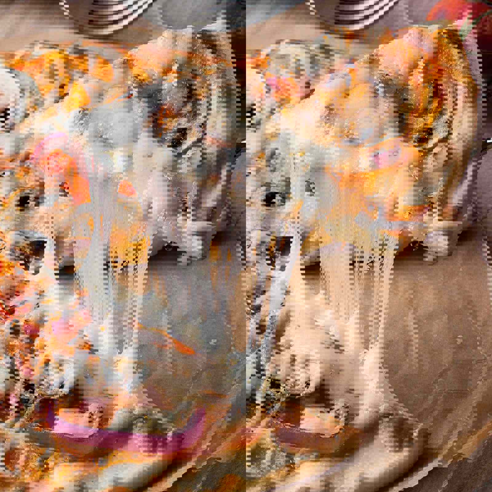 Slice of cheesy pizza being separated 