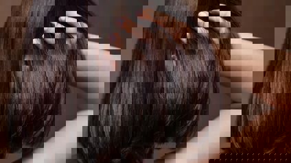 Person Running Fingers Through Shiny Hair