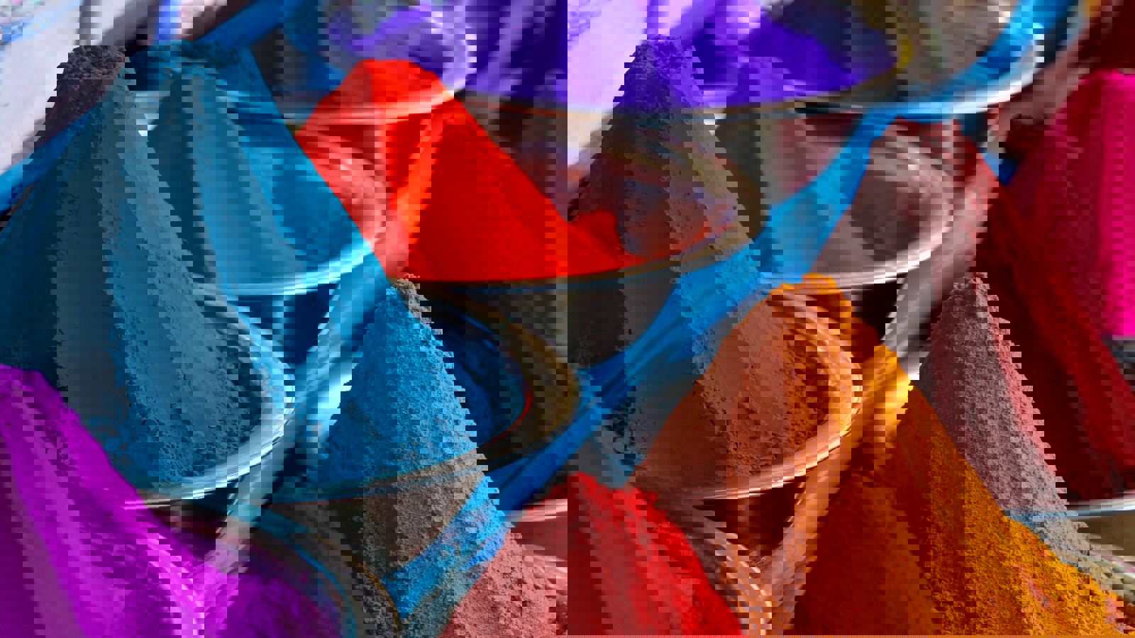 Bowls of coloured powders demonstrating cohesion