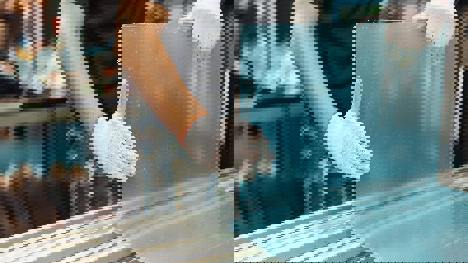 Worker bending plastic in a factory