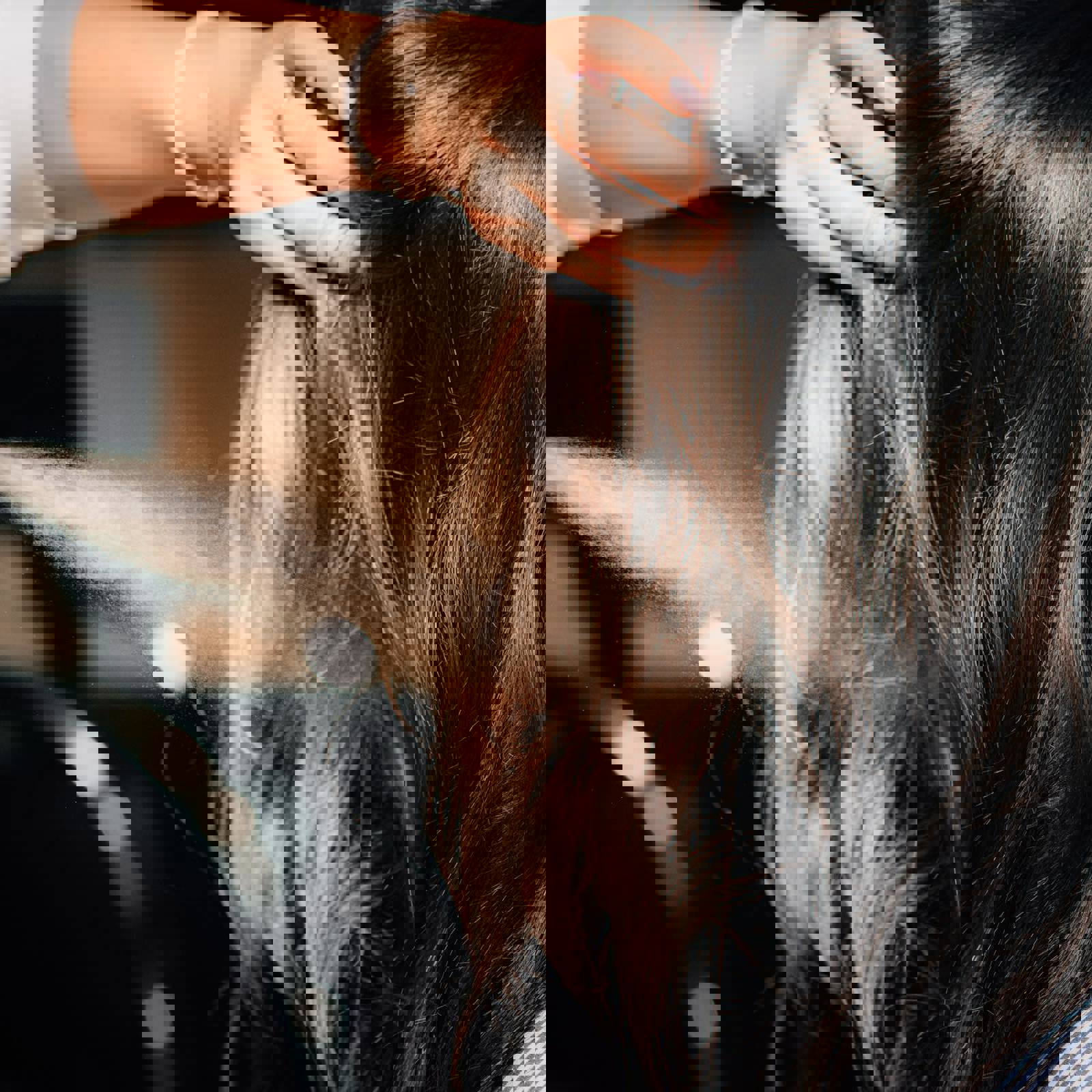 Hairdresser spraying hairspray on to customers hair