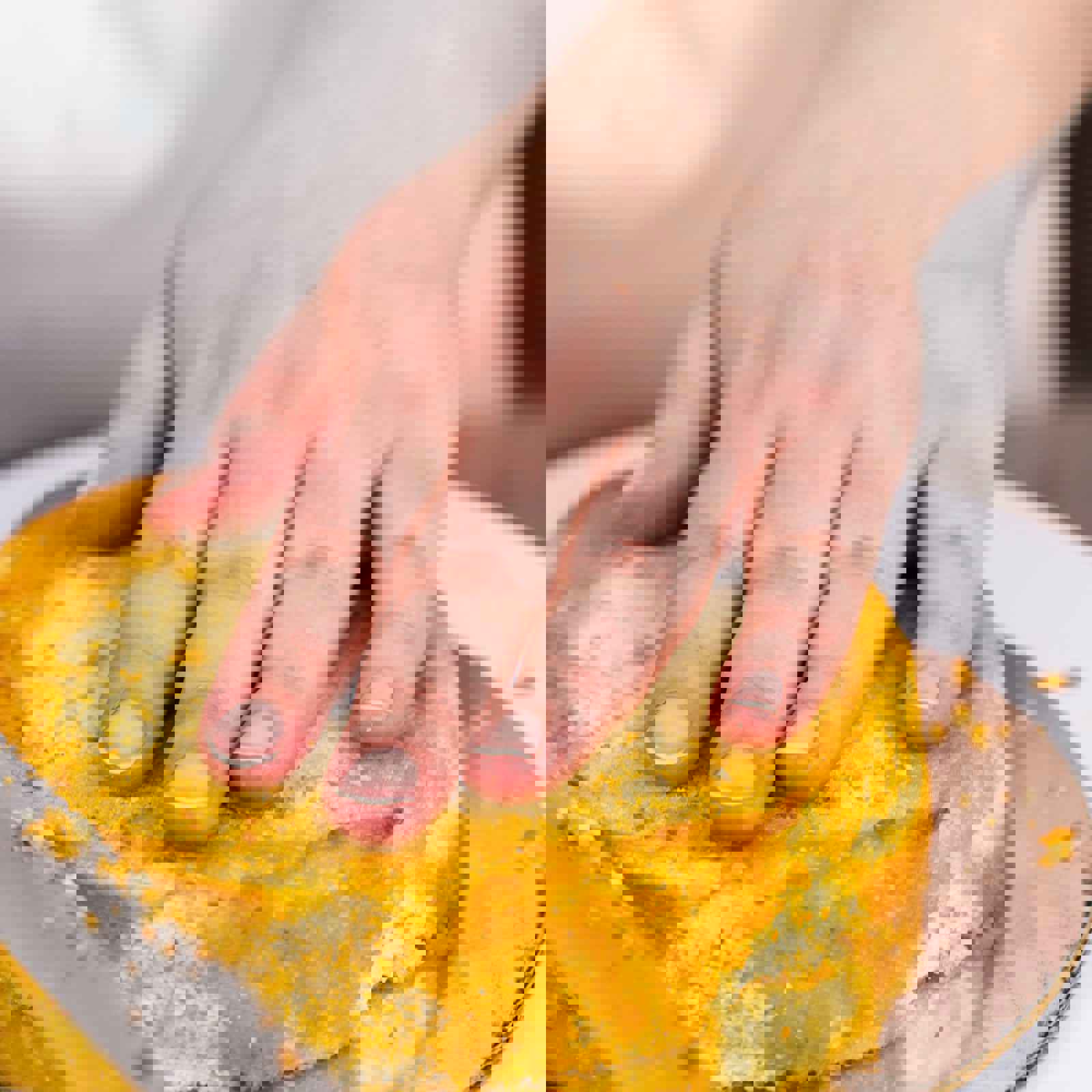 Baker testing top of sponge cake with hand