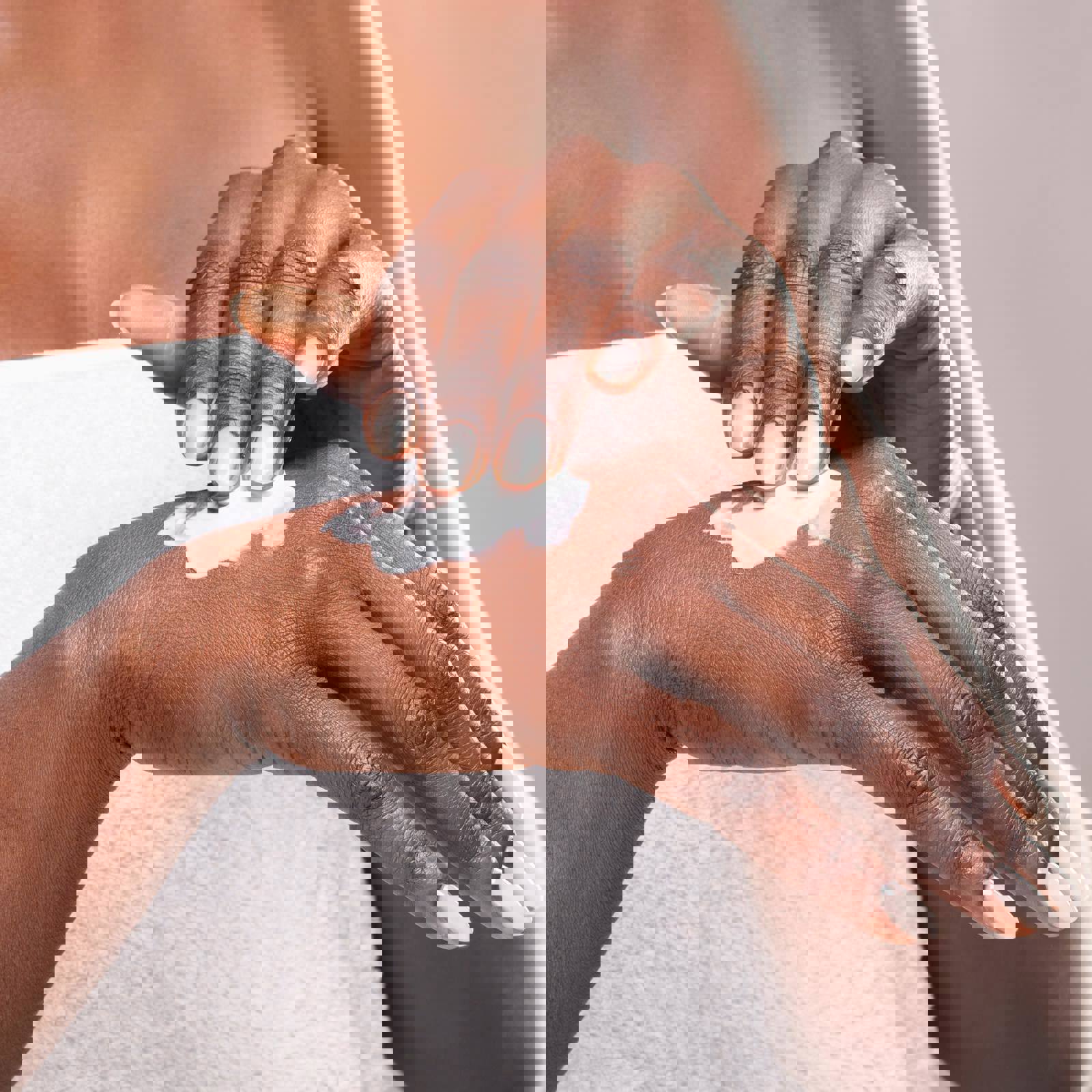 Person spreading skincare product on their hand
