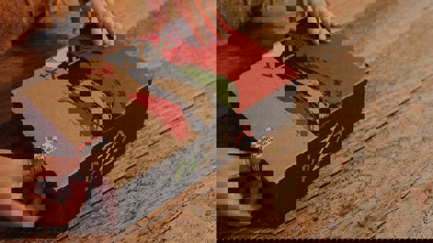 Hands Opening Cardboard Pizza Box