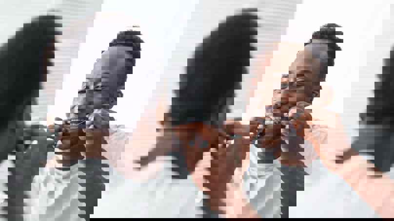 Person Flossing In Mirror